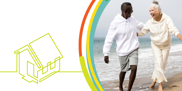 Couple on beach with house